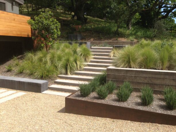large hillside landscaping with low maintenance plantings in a metal planter box