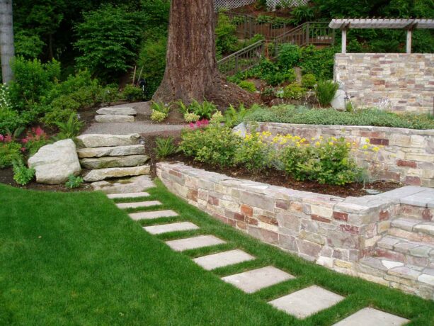 traditional low maintenance hillside landscaping with walkway and two steps