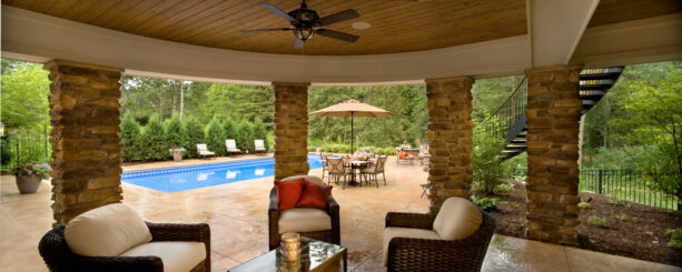 under deck patio in a pool side completed with stone columns