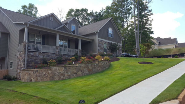 veneer fieldstone wall to terrace the hillside landscaping with low maintenance plantings