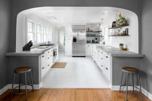 clean and polished galley kitchen with a breakfast bar at one end of each cabinet