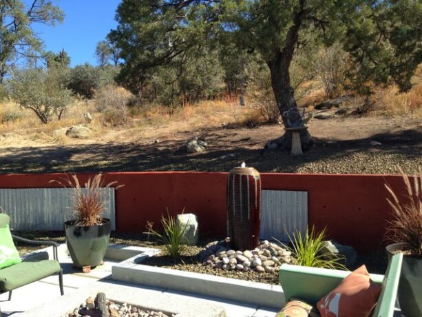 concrete retaining wall with corrugated metal treatment