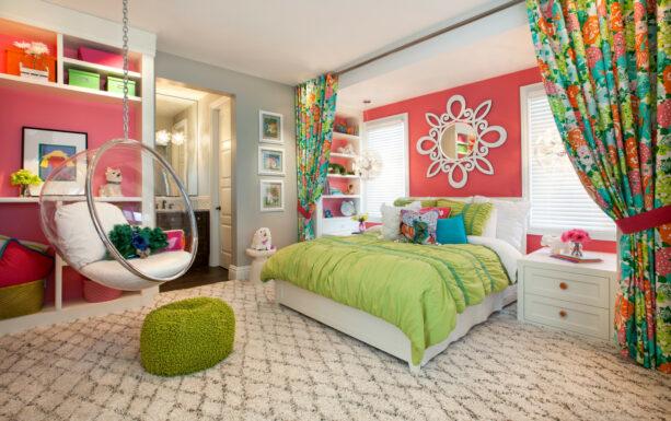 coral pink accent walls paired with green comforter and pillows for a bright bedroom
