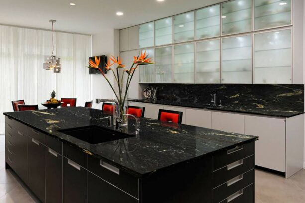 cosmic black galley kitchen with red stools at the breakfast bar