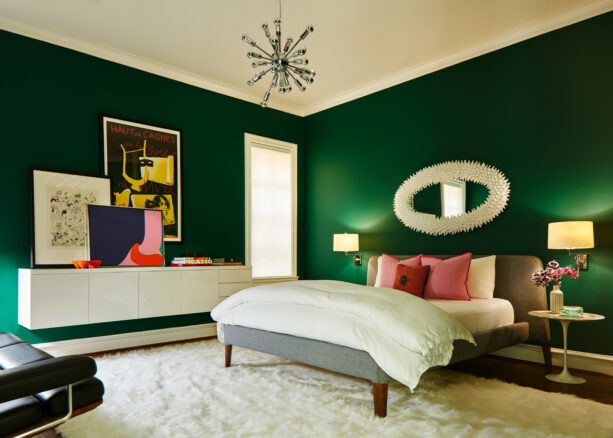 deep emerald green bedroom with a splash of pink accessories