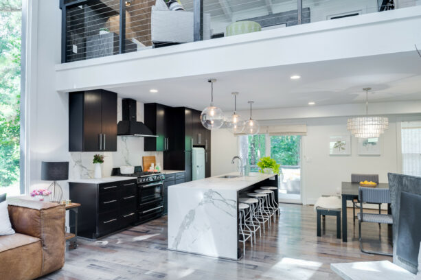 large and trendy galley kitchen with a breakfast bar on a waterfall island