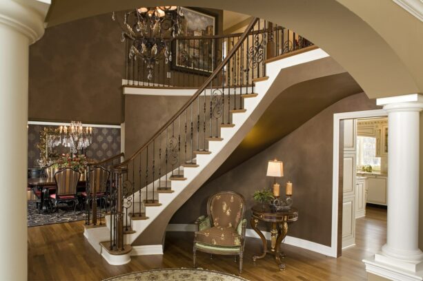 metal half wall stair railing with a heavy ornamentation and wood top