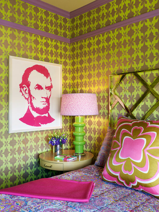 pink artwork hung in a bedroom with a green and purple patterned wallpaper
