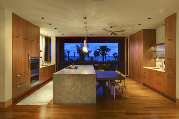 ultra-modern galley kitchen with two sides and a bi-leveled island for a breakfast bar
